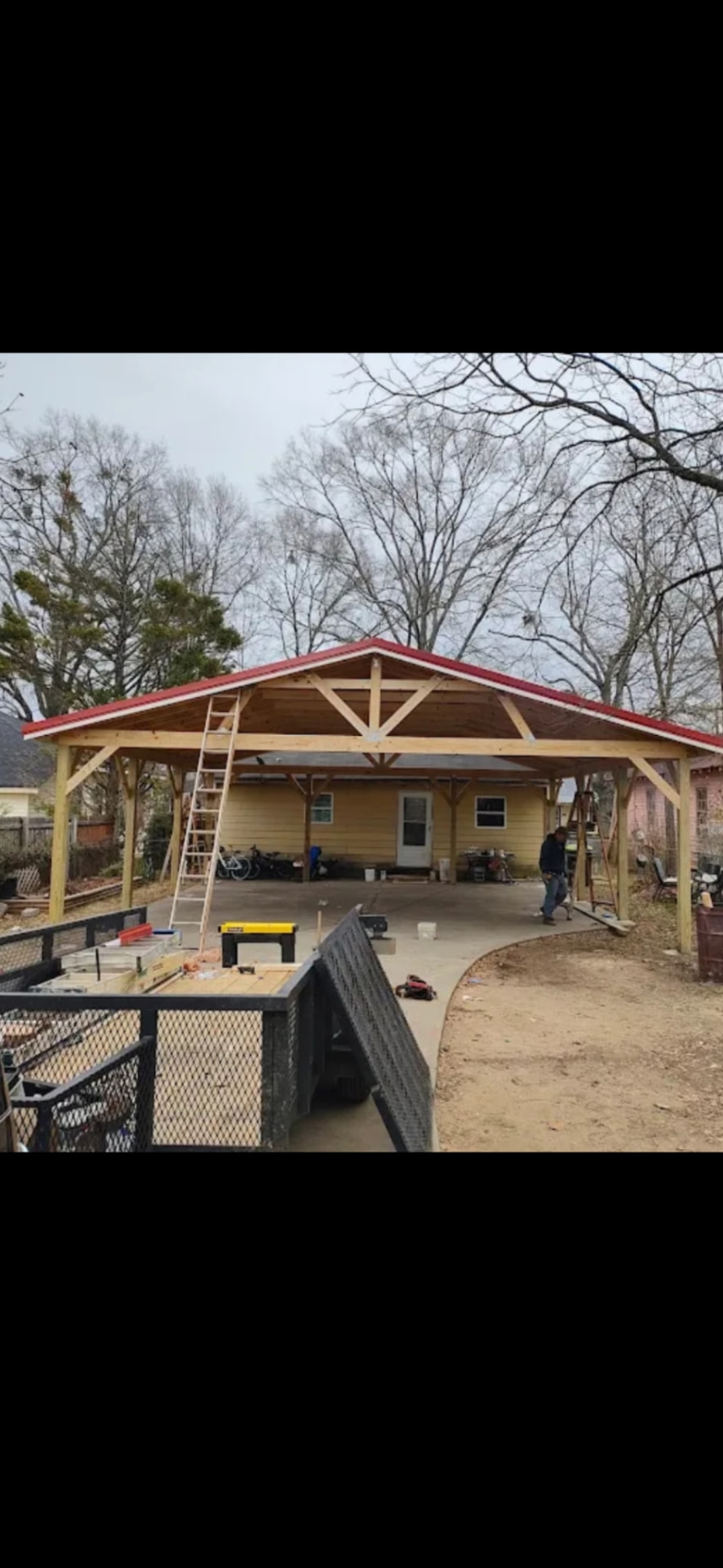 Carport build — wood frame with red roof